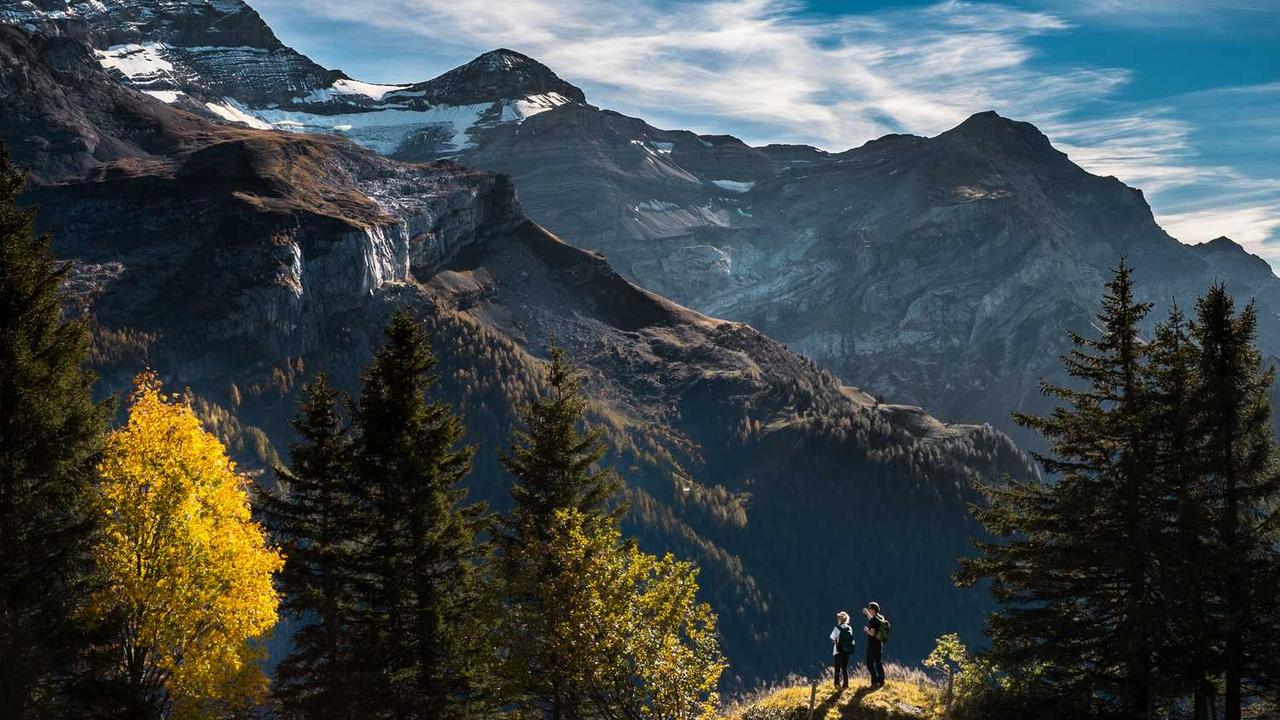 中年男子在海滩边，眺望着远方，海浪轻轻拍打着岸边